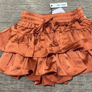 Size small. Burnt orange ruffled skirt. Brand new with tags.